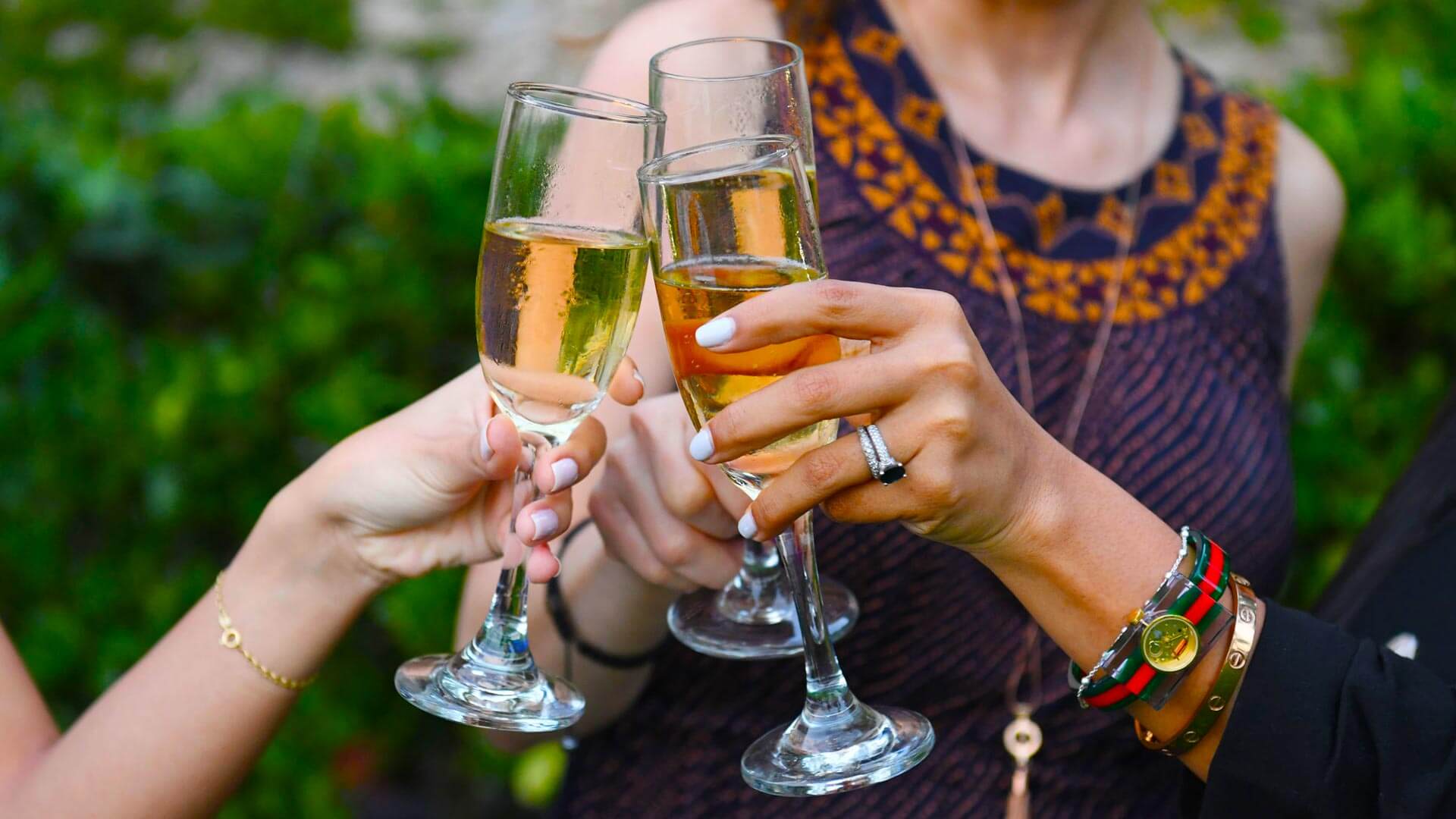 Ladies toasting Champagne glasses at daytime party in Miami