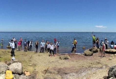 Group of campers gathered along the shore of Deering Point