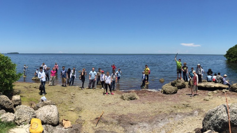 Group of campers gathered along the shore of Deering Point