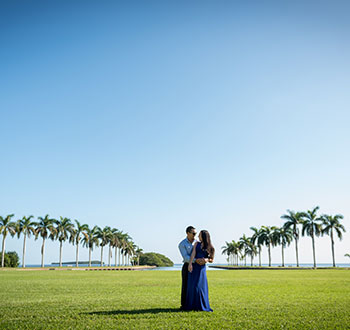 A couple on the front lawn conducting an engagement photoshoot.
