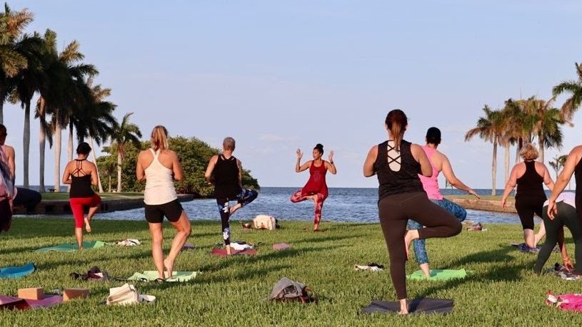 Small group on the main lawn participating in the Full Moon Yoga event