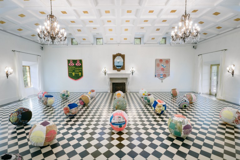 Stone House ball room decorated as one of Deering Estate's artist in residence exhibits