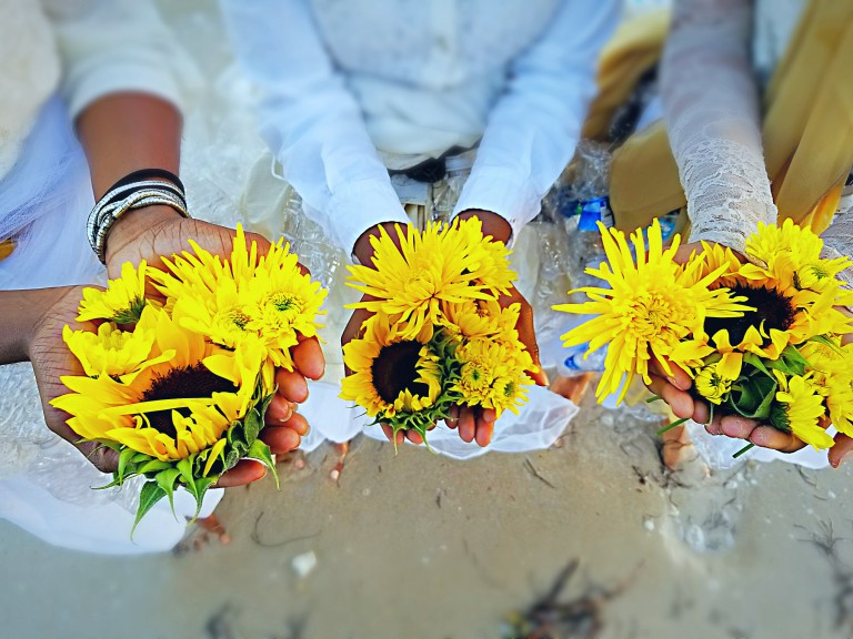 Group of people holding sunflowers