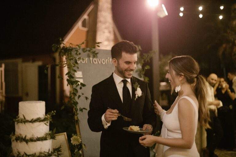 A bride and groom enjoying a slice of their wedding cake.