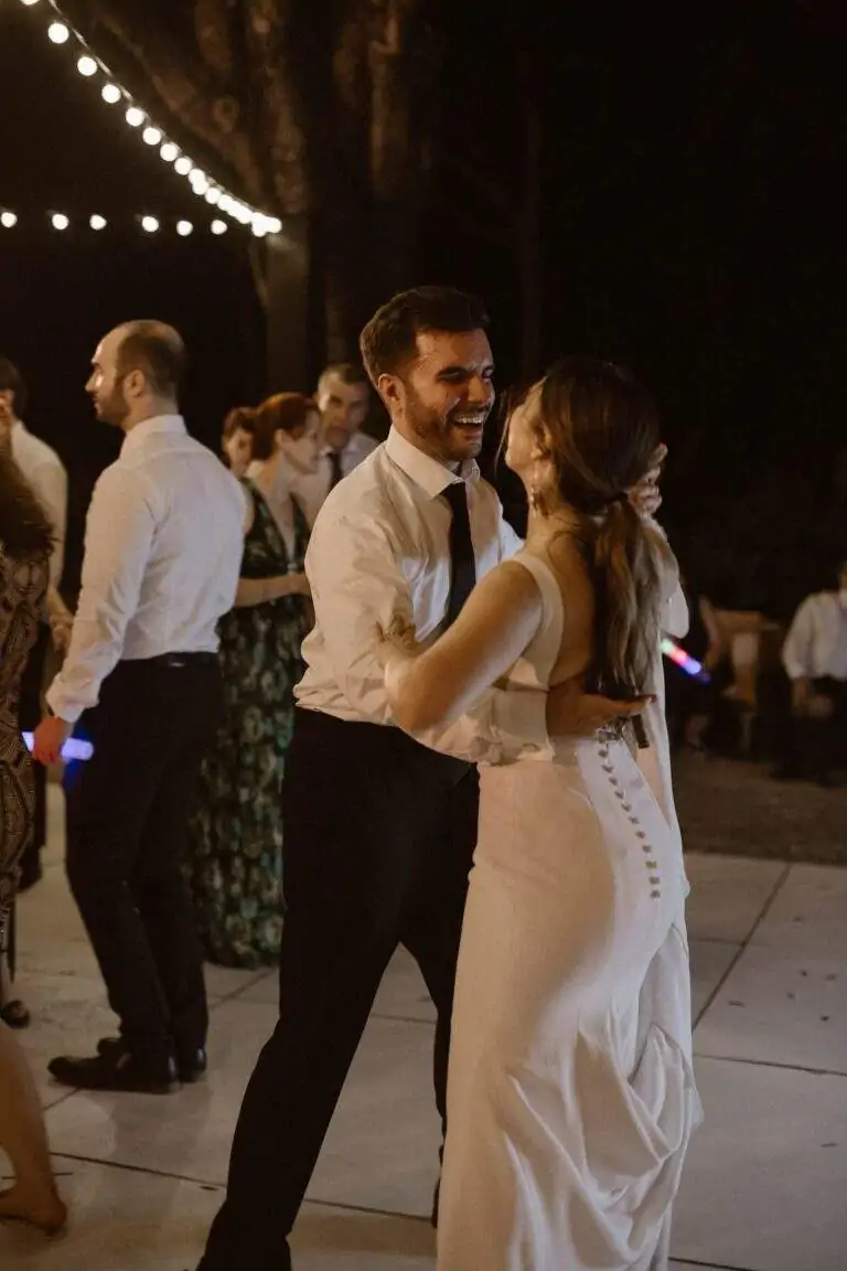 A bride and groom dancing together at their wedding reception.