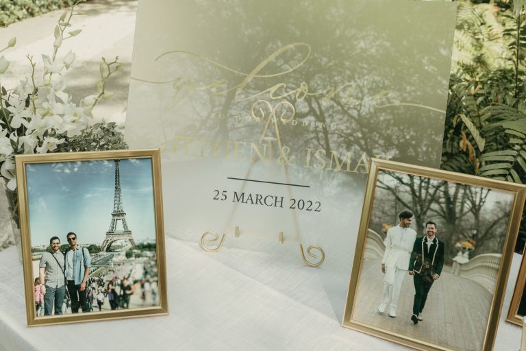 The wedding's welcome table for guests, featuring the grooms pictures
