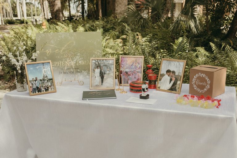 A wedding's welcome table for guests, featuring the grooms pictures and guest book