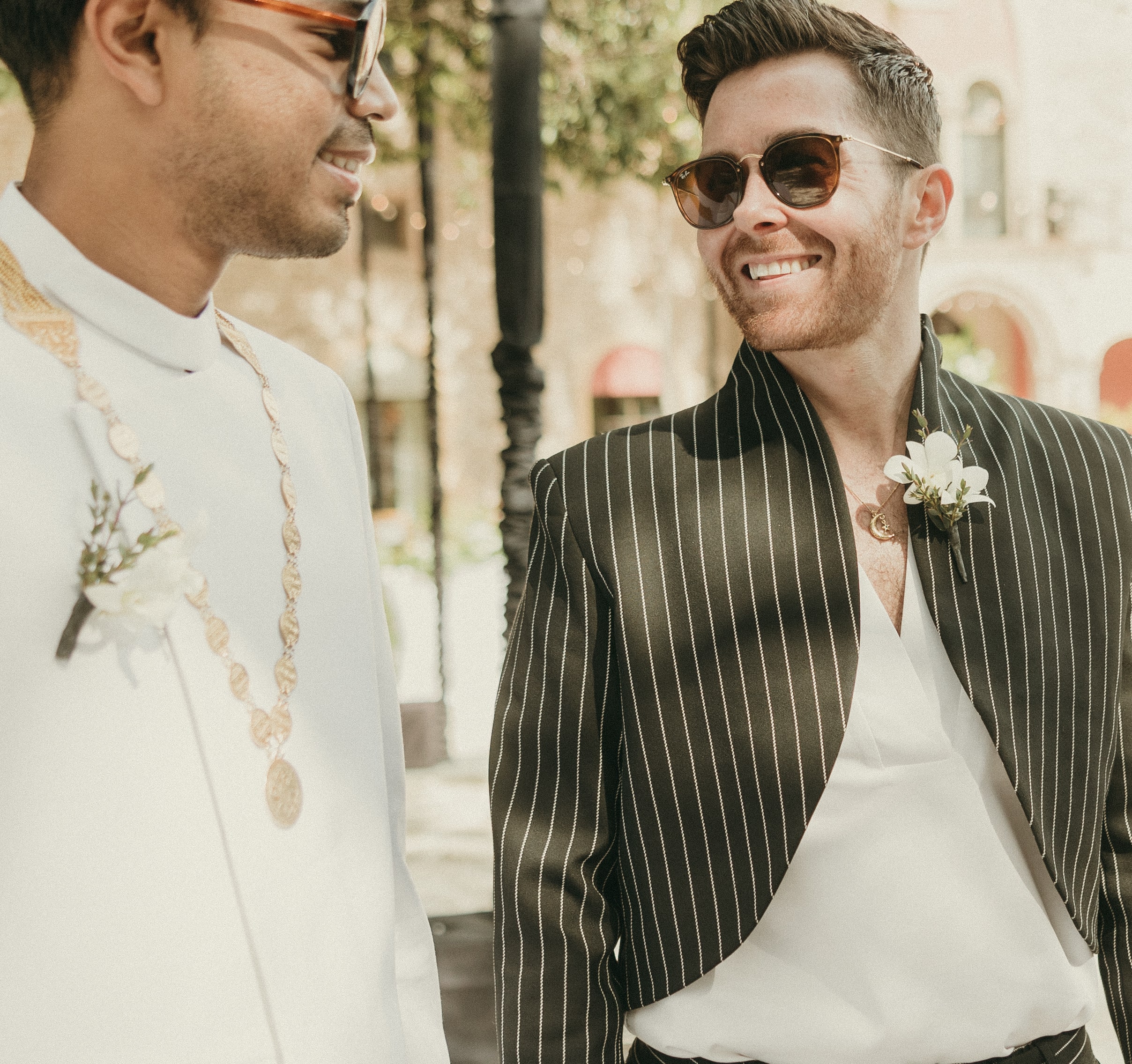 Grooms smiling at each other while viewing the reception-site before guests arrive