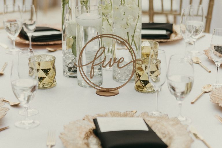 Detail shot of a table with gold and black details and place settings