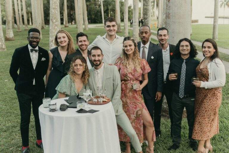 Some wedding guests taking a photo at Deering Estate's Royal Palm Grove