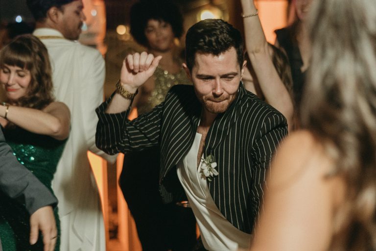 One of the grooms dancing with his wedding guests