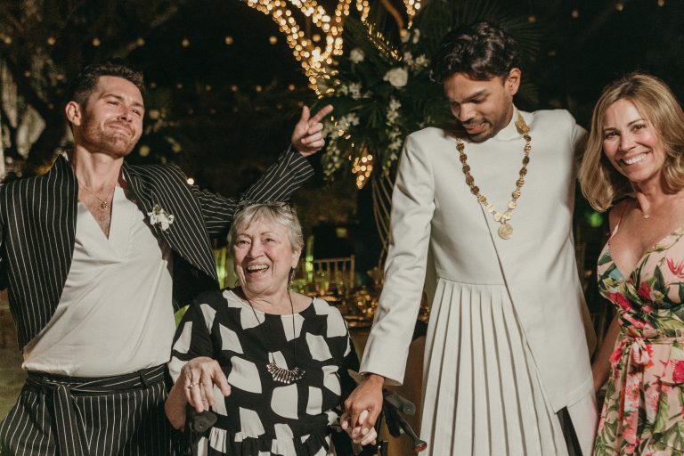 Grooms dancing with two wedding guests