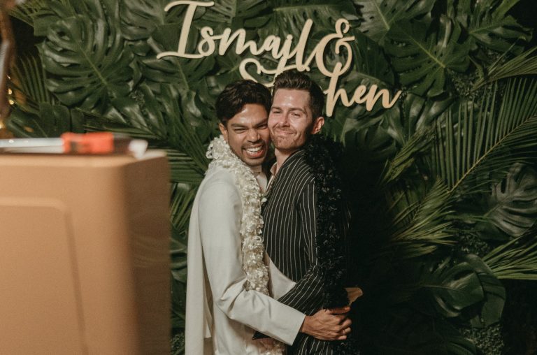 Both grooms enjoying the photo booth during the wedding
