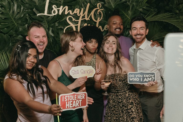 Wedding guests enjoying the coastal-themed photo booth