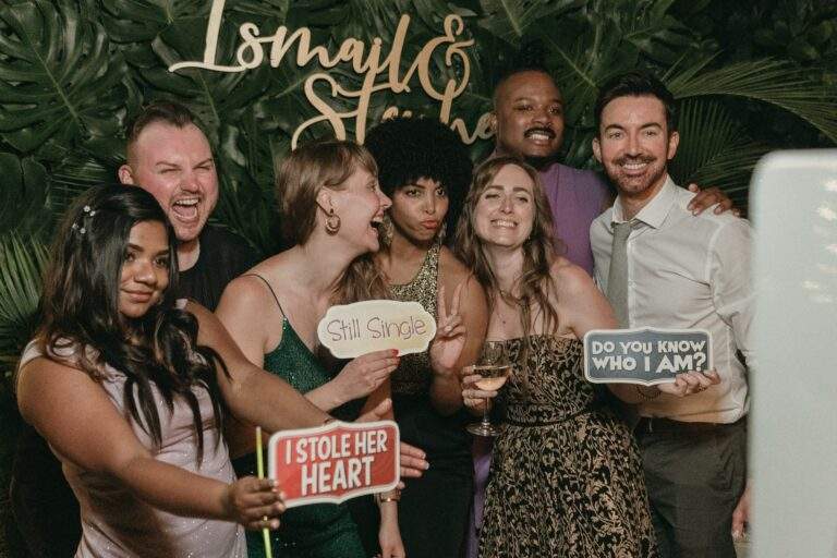 Wedding guests enjoying the coastal-themed photo booth