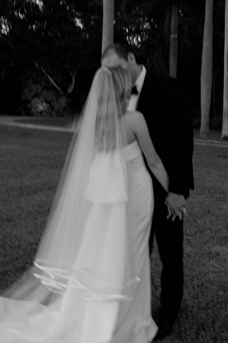 A blurry black and white still of a bride and groom.
