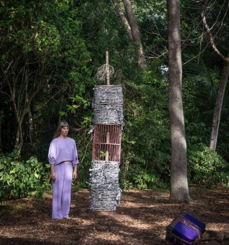 Artist Maria Theresa Barbist stands next to her art piece titled "Babylonischer Turm I-V (Deering Estate)."