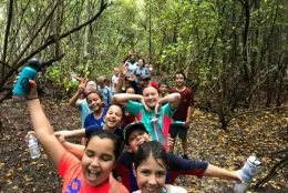 Group of campers hiking through the tropical hardwood hammocks of Deering Estate.